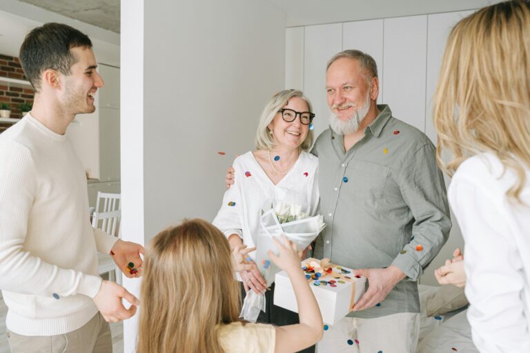 A joyful family gathering with gifts and confetti, celebrating togetherness and happiness indoors.